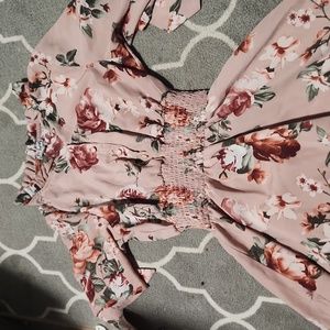 This knee long dress that is pink with lots of roses.